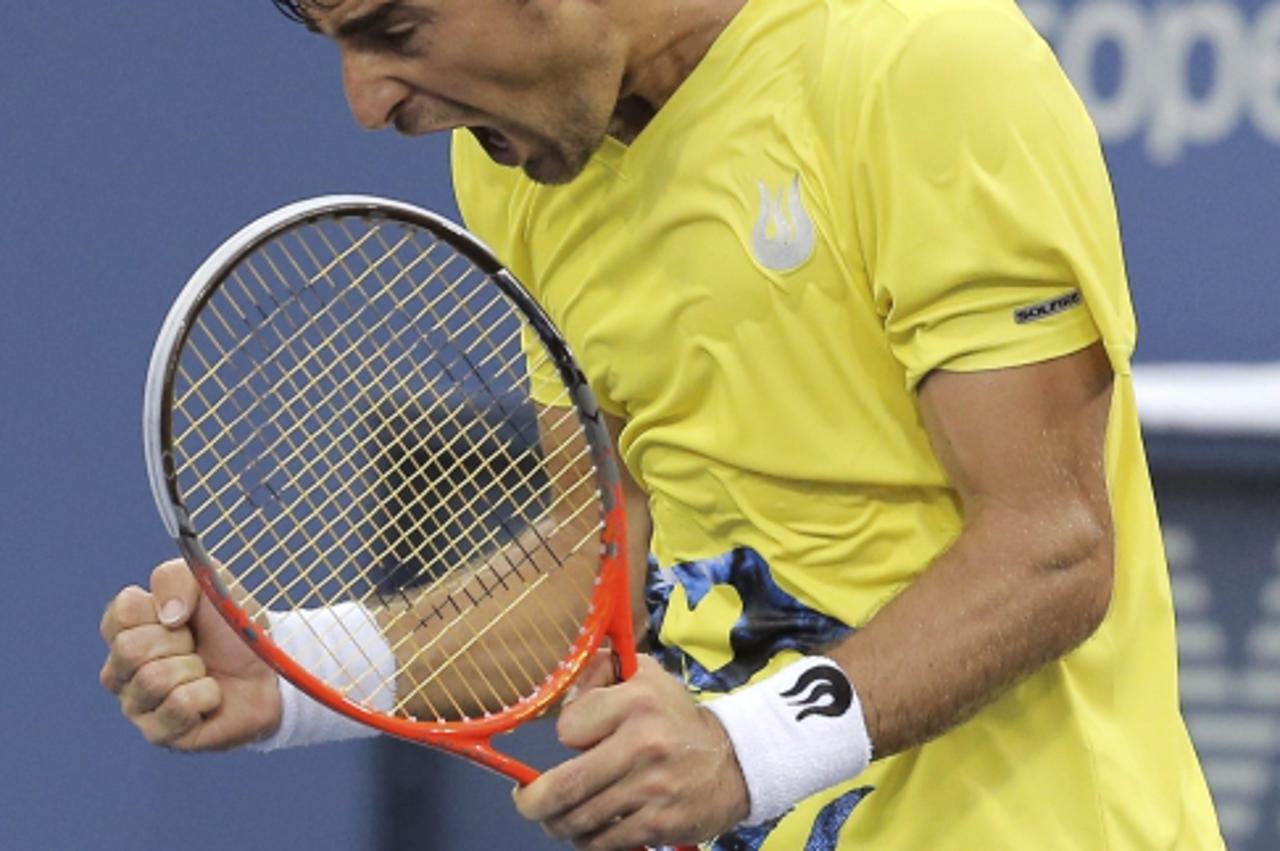 'Ivan Dodig of Croatia celebrates after defeating Fernando Verdasco of Spain at the U.S. Open tennis championships in New York, August 26, 2013. REUTERS/Ray Stubblebine (UNITED STATES  - Tags: SPORT T