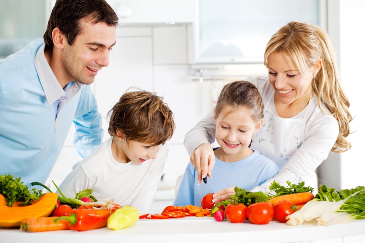 Portrait of a happy family preparing vegetables for meal together in the kitchen.    [url=http://www.istockphoto.com/search/lightbox/9786778][img]http://dl.dropbox.com/u/40117171/family.jpg[/img][/url]  [url=http://www.istockphoto.com/search/lightbox/9786