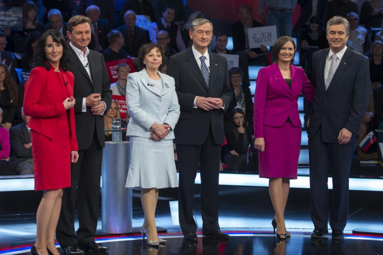 'Presidential candidate Borut Pahor (2nd L), with his wife Tanja Pecar (L), candidate and current Slovenian President Danilo Turk (Center R), with wife Barbara Miklic (Center L), and Milan Zver (R), w