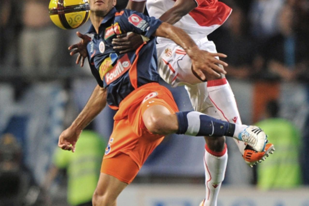 \'Montpellier\'s Defender Emir Spahic (L) vies with Monaco\'s Forward Benjamin Moukandjo (R) during the French L1 football match Montpellier vs Monaco, on May 21, 2011 at the Mosson stadium in Montpel