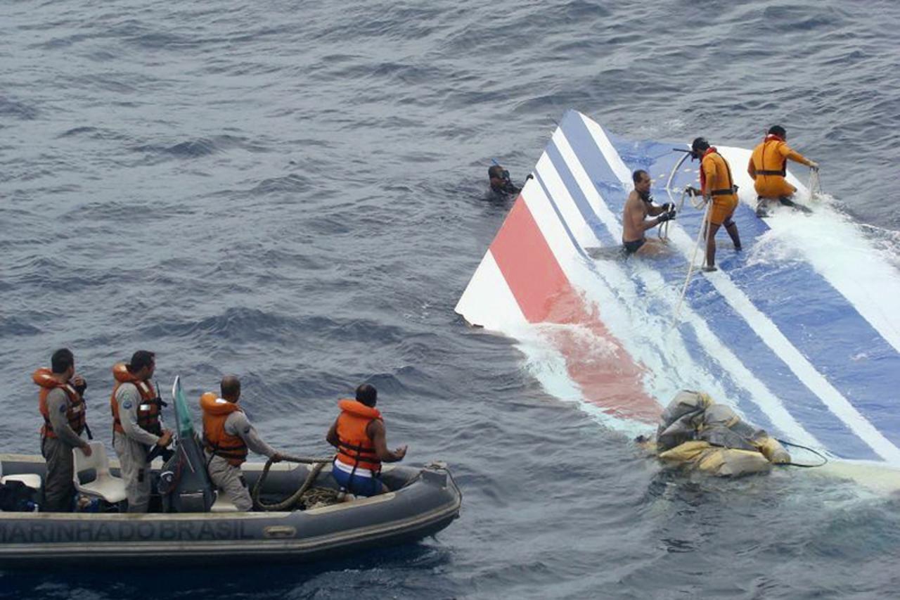 'Brazilian Navy sailors pick up a piece of debris from Air France flight AF447 out of the Atlantic Ocean, some 745 miles (1,200 km) northeast of Recife, in this handout photo distributed by the Navy J