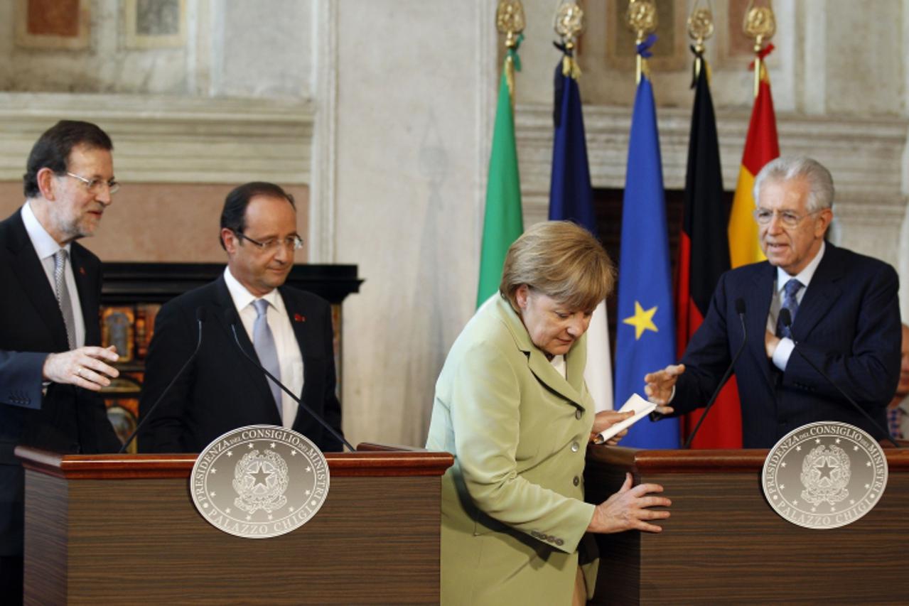 'German Chancellor Angela Merkel (2nd R) leaves followed by Italian Prime Minister Mario Monti (R),  French President Francois Hollande and Spanish Prime Minister Mariano Rajoy (L) after a news confer