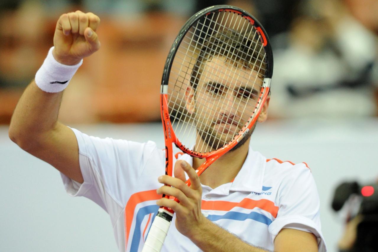 'Marin Cilic of Croatia celebrates after beating Janko Tipsarevic of Serbia in the final of the St. Petersburg Open tennis tournament in St. Petersburg, on October 30, 2011.AFP PHOTO/ KIRILL KUDRYAVTS