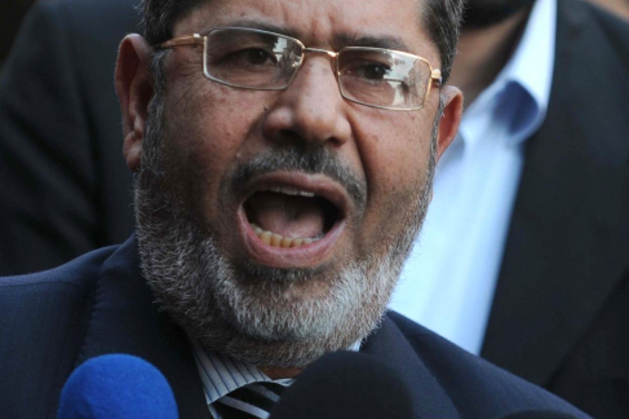 '(FILES) -- File picture taken on January 3, 2012 shows Muslim Brotherhood member Mohamed Morsi addressing the media outside a polling center in Qaliubia, about 40 kms north of Cairo, during the third