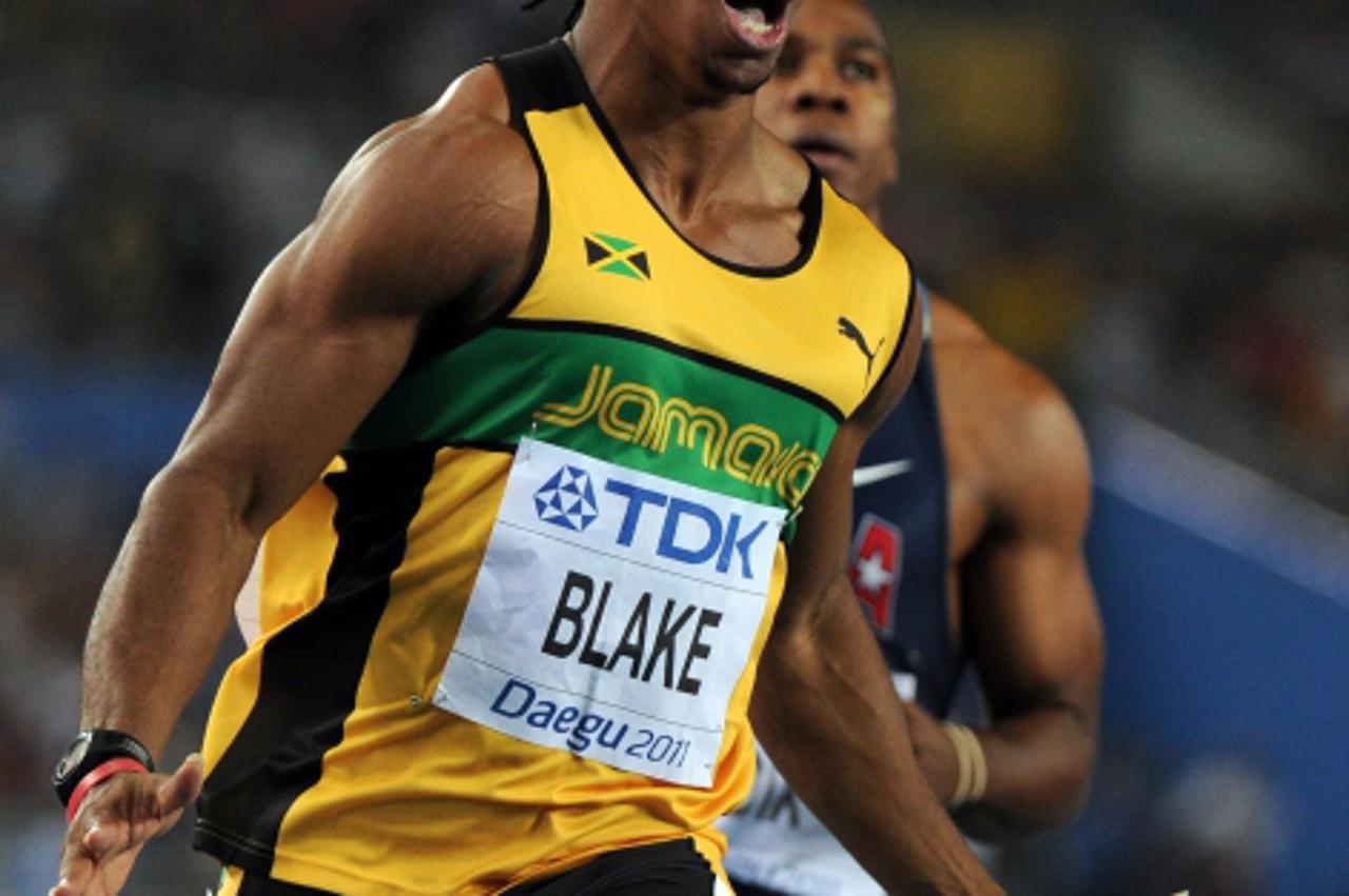 \'Jamaica\'s Yohan Blake celebrates winning gold in the men\'s 100 metres final at the International Association of Athletics Federations (IAAF) World Championships in Daegu on August 28, 2011.     AF