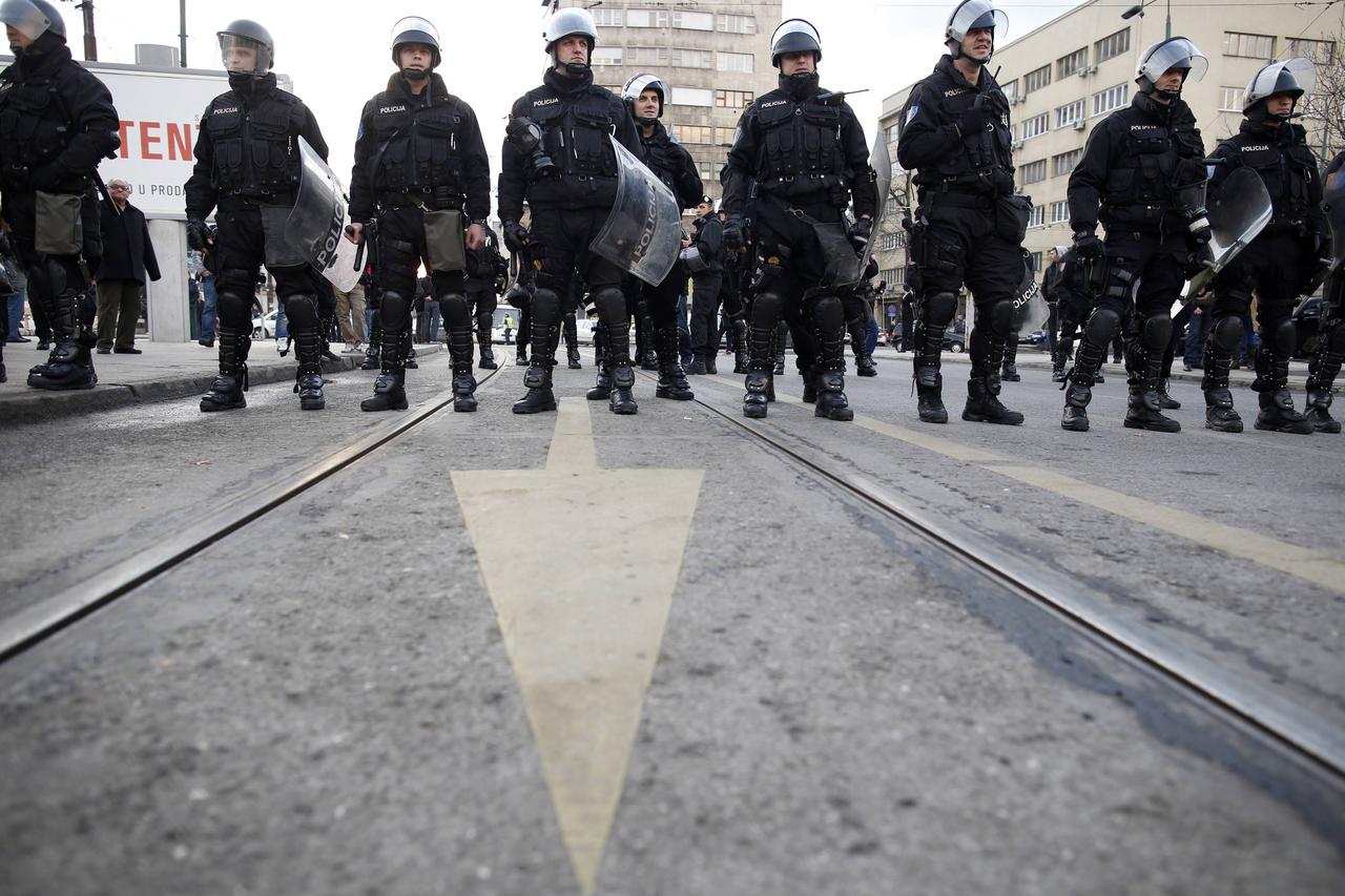 Police stand in their positions as they face anti-government protesters in Sarajevo February 6, 2014. Hundreds of people turned out in solidarity in the capital Sarajevo, with teenagers throwing eggs and stones at a government building and fought with pol