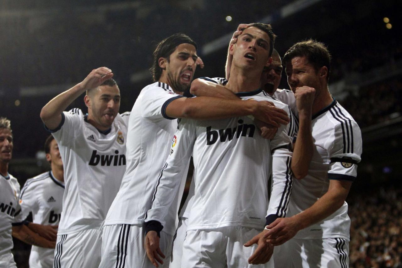 'Real Madrid's Cristiano Ronaldo celebrates with team-mates scoring a goal against Atletico Madrid during their Spanish first division match at the Santiago Bernabeu stadium in Madrid, December 1, 20