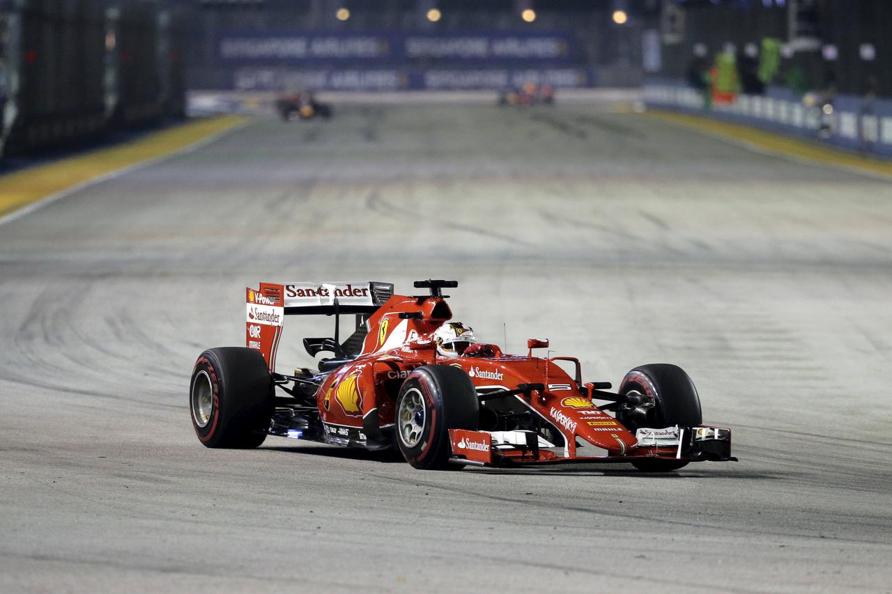 Ferrari Formula One driver Sebastian Vettel of Germany drives during the Singapore F1 Grand Prix at the Marina Bay street circuit September 20, 2015. REUTERS/Tim Chong