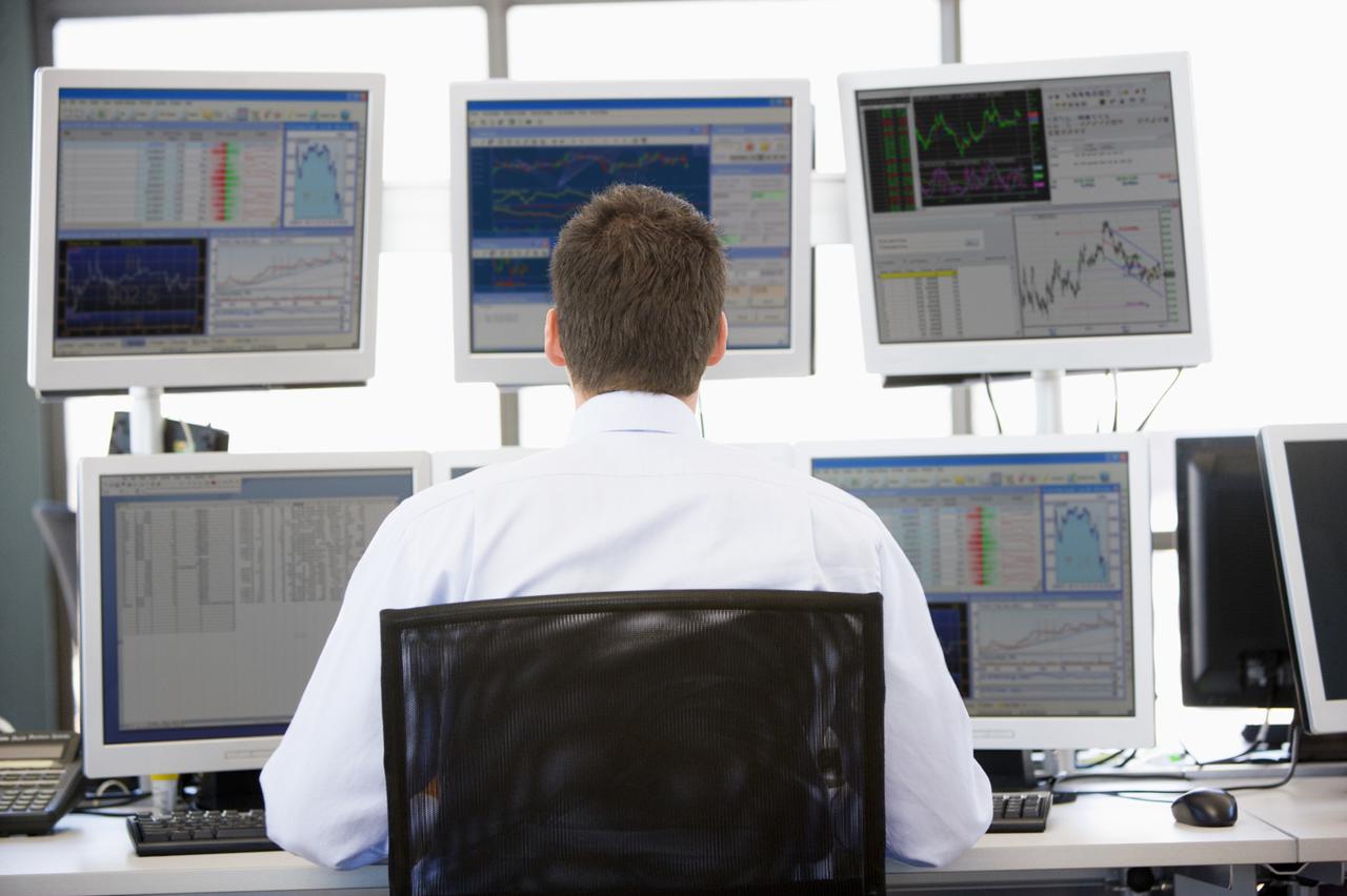 Stock Trader Looking At Multiple Monitors; Shutterstock ID 35025070; PO: aol; Job: production; Client: drone