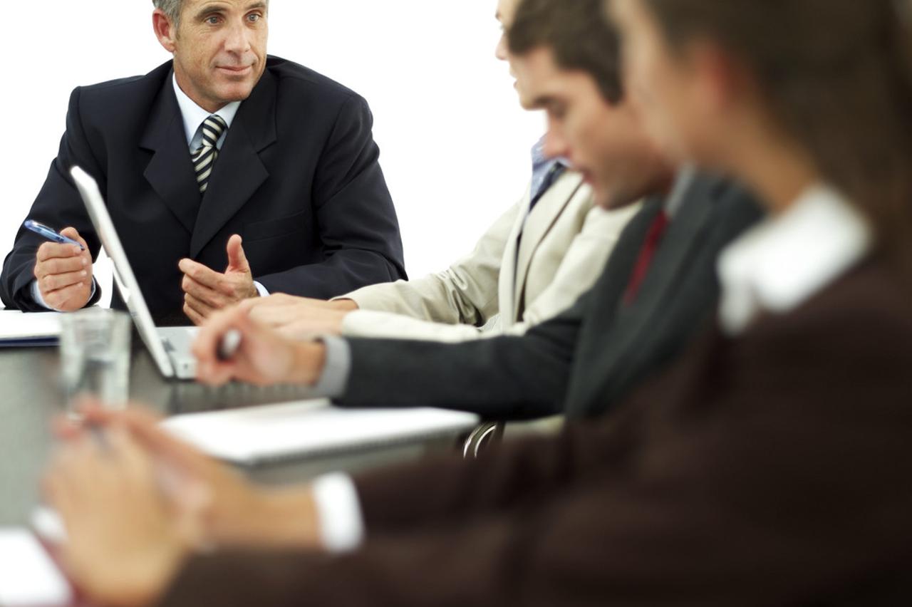 Businessman Conducting a Meeting with His Staff --- Image by © Royalty-Free/Corbis