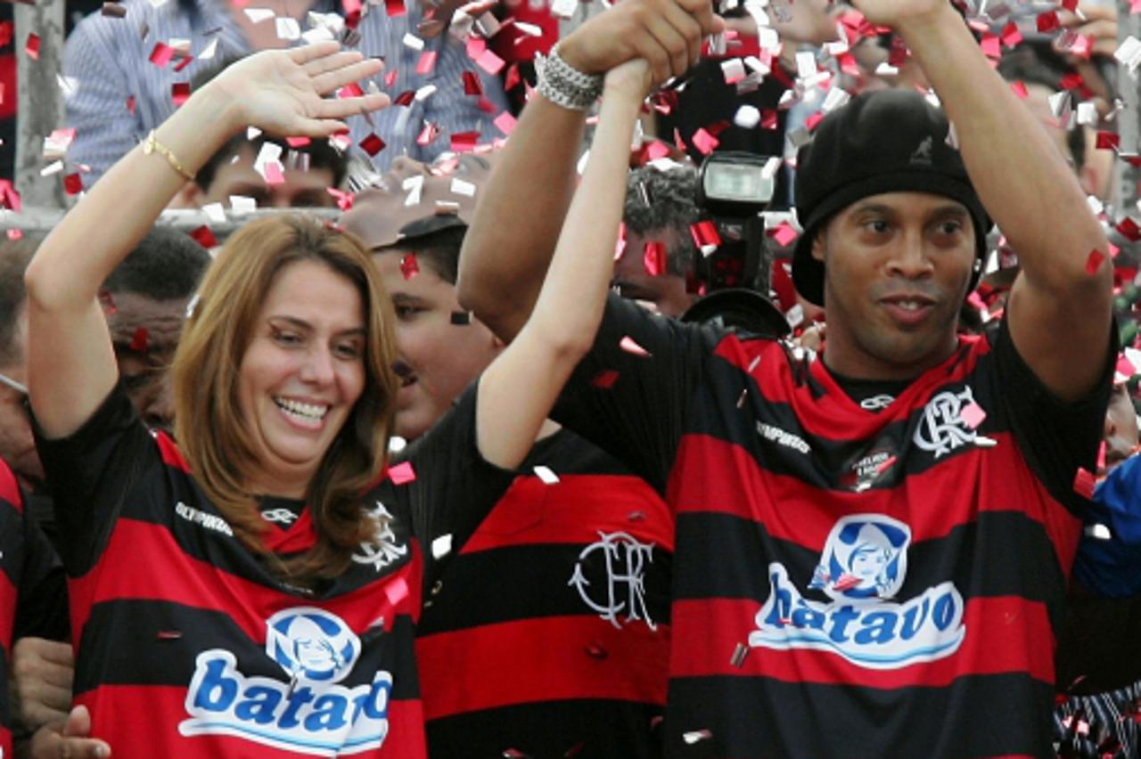 'Brazilian football club Flamengo\'s newly signed member Ronaldinho Gaucho (R) and club\'s president Patricia Amorim wave to supporters during his presentation in Rio de Janeiro, Brazil on January 12,