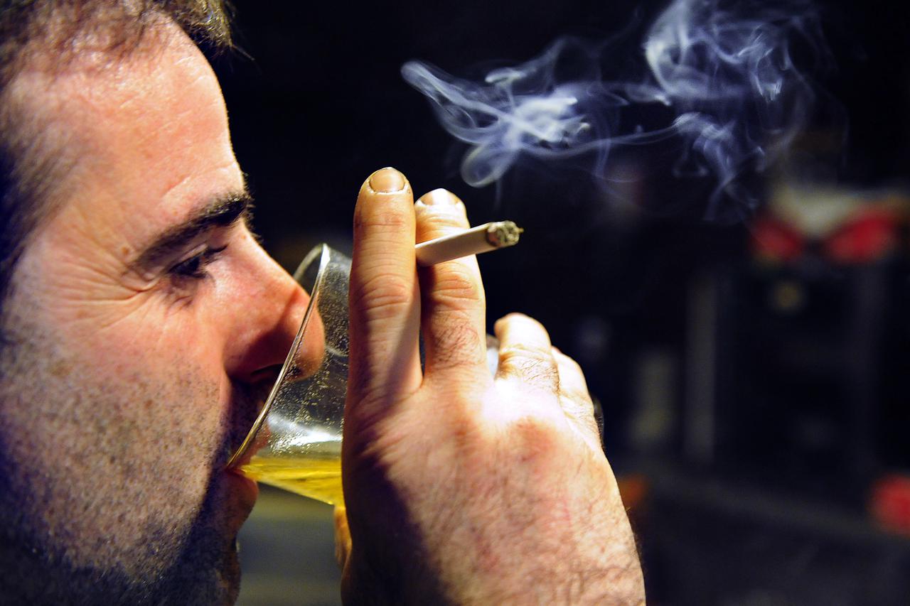 A man drinks beer while smoking a cigarette at the Goiritxu bar in Guernica December 25, 2010. A tough new law expected to pass the Spanish Senate on January 2, 2011 will prohibit smoking in bars as well as playgrounds, schools and hospitals. REUTERS/Vinc