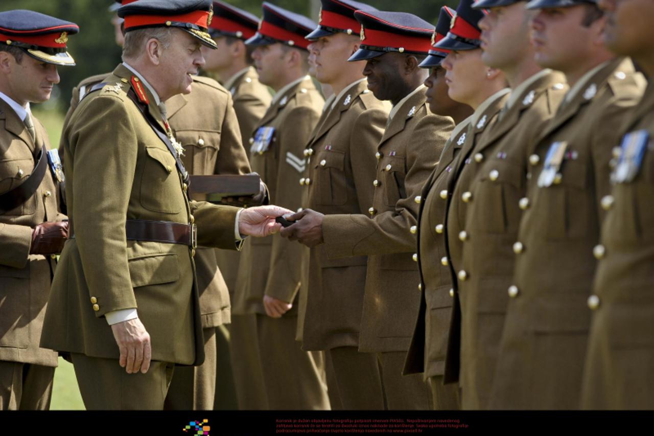 'General Sir Timothy Granville-Chapman GBE KCB hands out Operation Herrick medals for service in Afghanistan, to soldiers from the 1st Regiment Royal Horse Artillery parade, at Tattoo Parade Ground, T