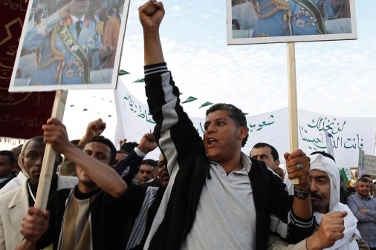 \'Supporters chant slogans towards Libyan leader Muammar Gaddafi during a ceremony marking the birth of Prophet Mohammad in Tripoli February 13, 2011. Palestinian refugees should capitalise on the wav