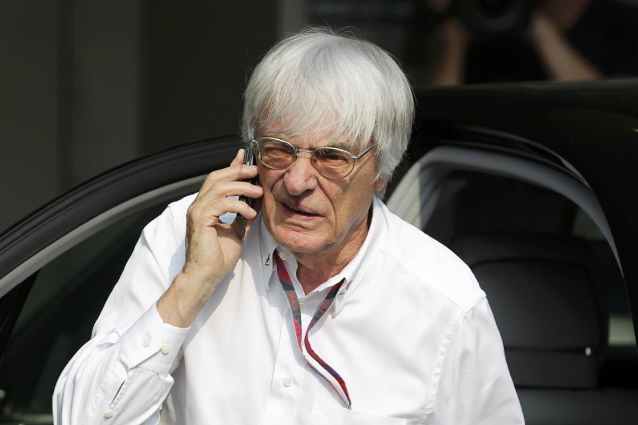 'Formula One commercial supremo Bernie Ecclestone arrives for the third practice session of the Singapore F1 Grand Prix at the Marina Bay street circuit in Singapore September 24, 2011.  REUTERS/Tim C