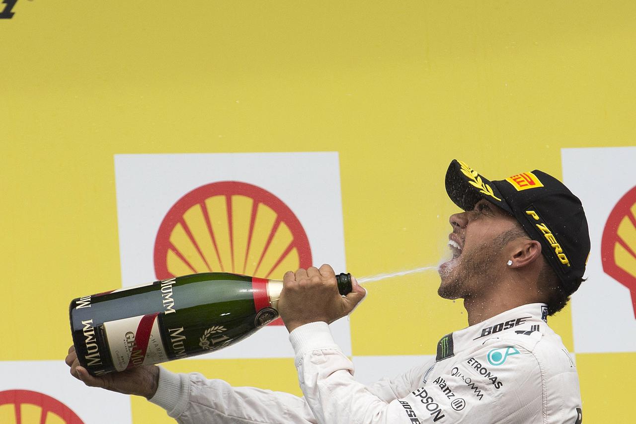 Mercedes Formula One driver Lewis Hamilton of Britain (L) celebrates his victory in the Belgian F1 Grand Prix in Spa-Francorchamps August 23, 2015.  REUTERS/Yves Herman