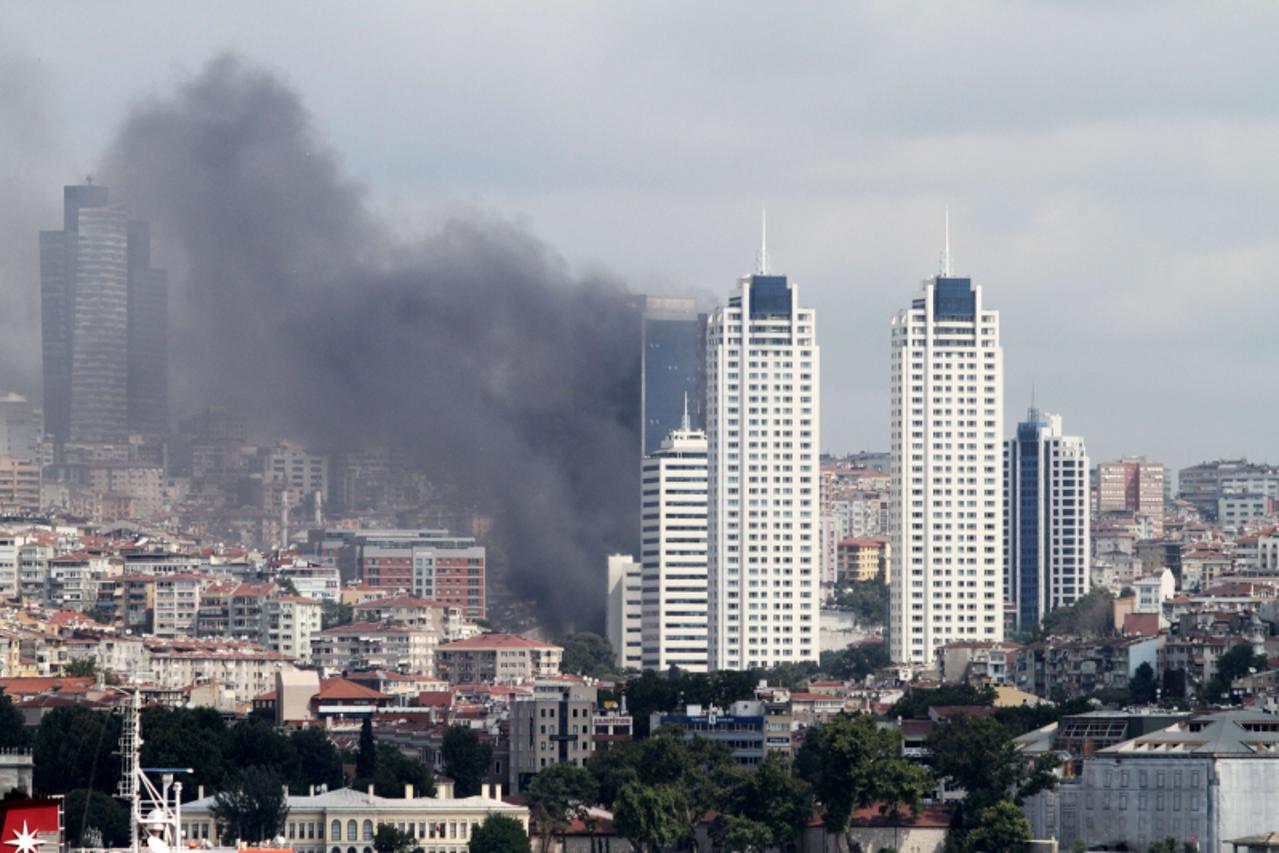'Photo taken on July 17, 2012 shows dark clouds of smoke billowing over the Besiktas district of Istanbul, after a fire broke out at a 42-storey building on July 17, 2012.  There were no immediate rep
