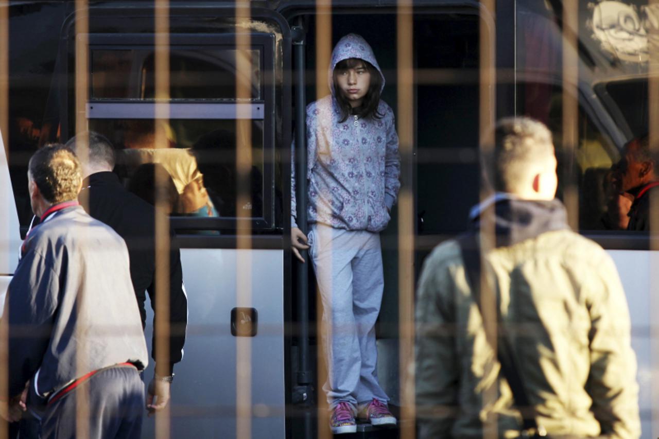 'An ethic Albanian girl looks from a bus as she waits for departure to EU in southern Serbian border town of Presevo, October 20, 2012. There is growing alarm within the European Union at the number o