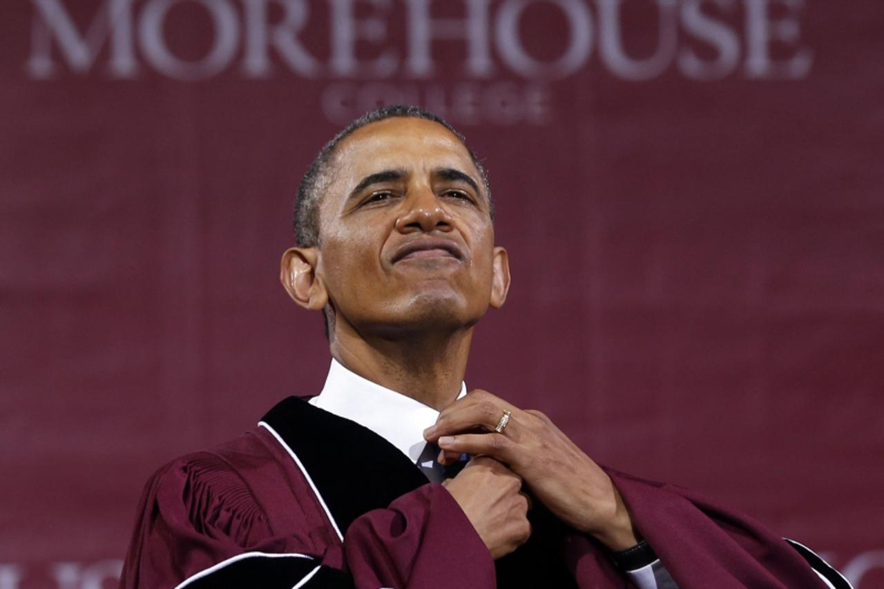 'U.S. President Barack Obama adjusts his tie before receiving an honorary Doctor of Laws degree at the graduation ceremony of the class of 2013 at Morehouse College in Atlanta, Georgia May 19, 2013.  