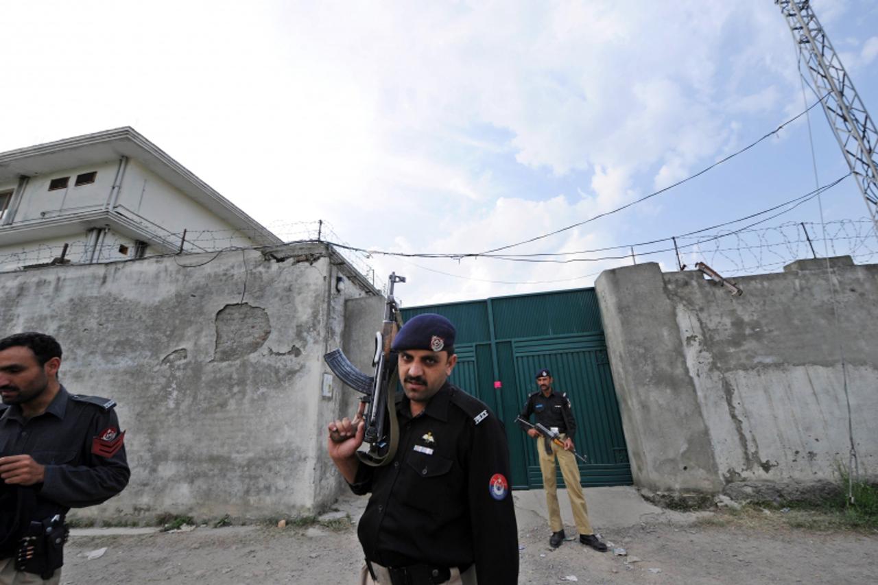 'Pakistani policemen stand guard outside the hideout house of slain Al-Qaeda leader Osama bin Laden in Abbottabad on May 5, 2011.  US officials said they gave no notice to Pakistan before the May 2, 2