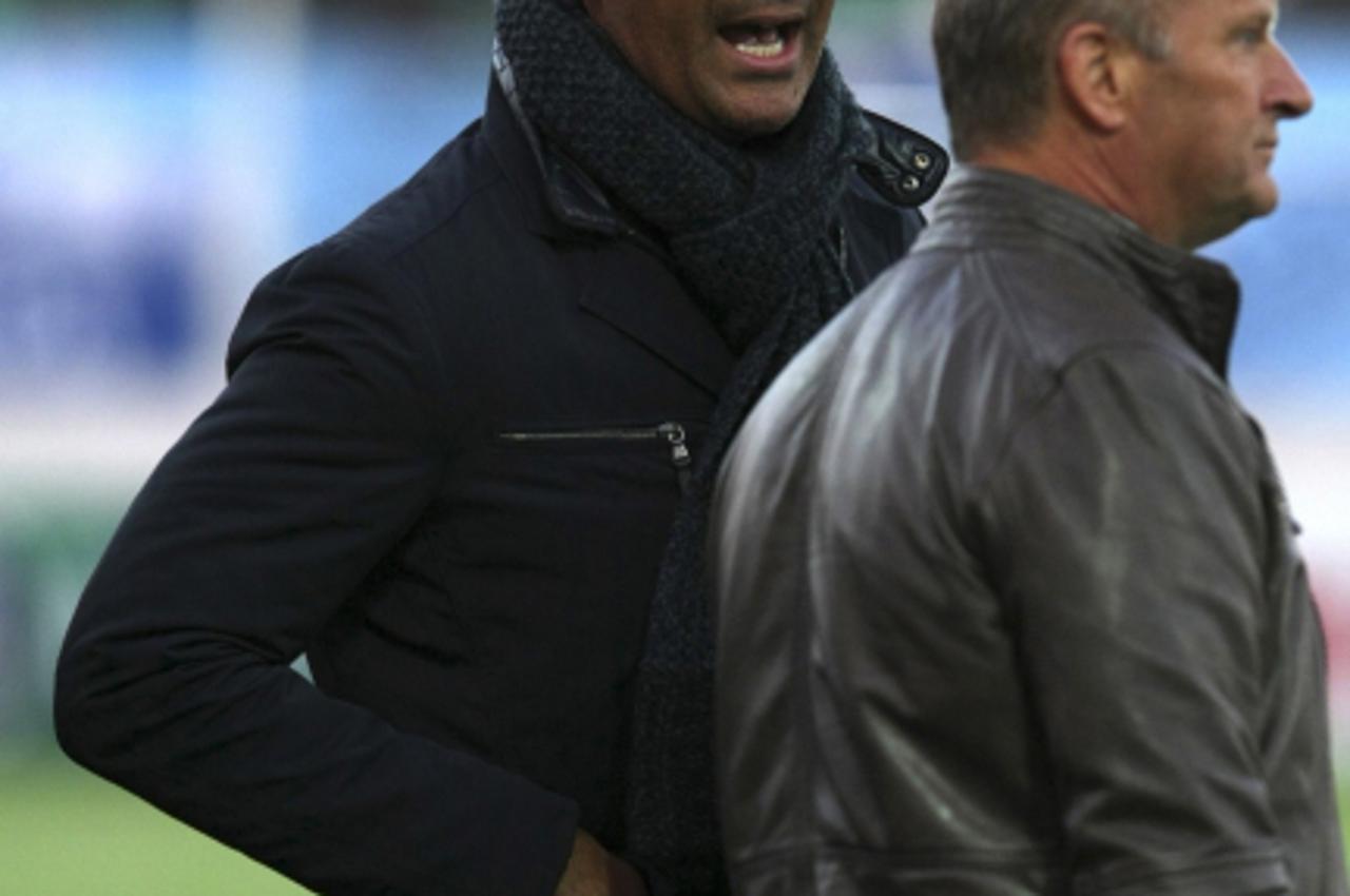 'Former Dutch international Ruud Gullit (L), coach of Russian Premier League side Terek Grozny, shouts to his players during his first match in charge in Grozny March 13, 2011. Terek lost to  Zenit St